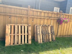 pallets leaning against a fence