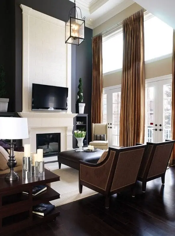 Distract the eye from tall walls with large curtains and oversized light fixtures. 
