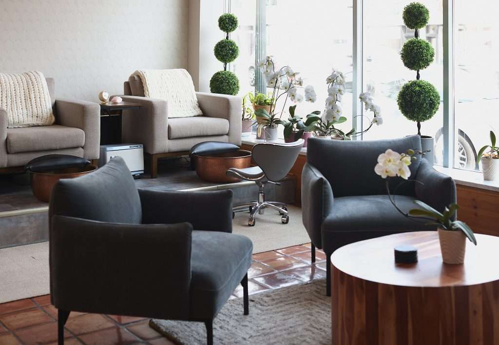 Aurora Spa 10 Modern lounge with plants and seating, featured copper foot scrub basins and Japanese Design by Tiffany Hanken Design.