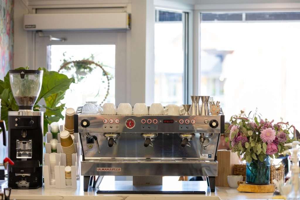 Oh Crêpe! Creperie & Café 15 Coffee machine with flowers and decor at Oh Crepe in Edina.