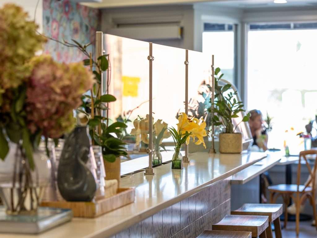 Oh Crêpe! Creperie & Café 14 Bright café interior with flowers.