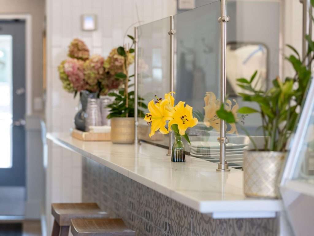 Oh Crêpe! Creperie & Café 11 Bright flowers on a restaurant counter.