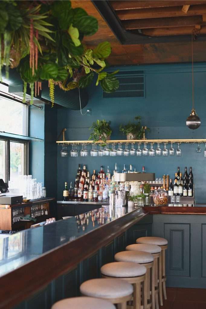 Minneapolis Restaurant Design 18 Stylish bar with plants and drinks