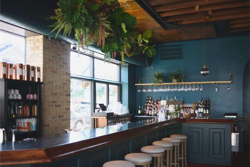 Minneapolis Restaurant Design 17 Stylish bar with greenery and seating