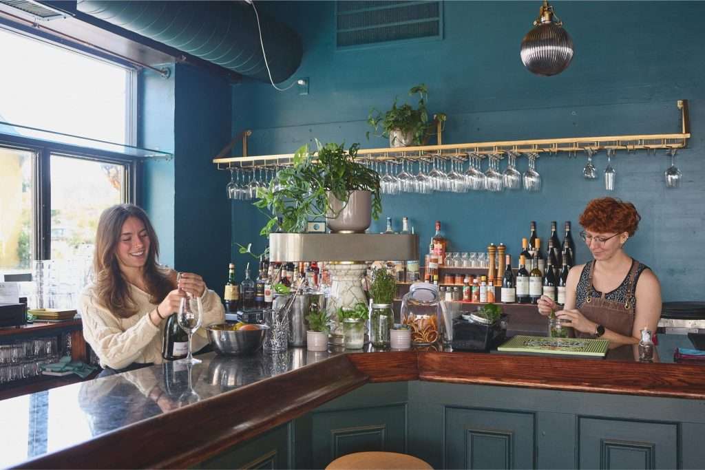 Minneapolis Restaurant Design 13 Two bartenders preparing drinks at bar in Uptown Minneapolis