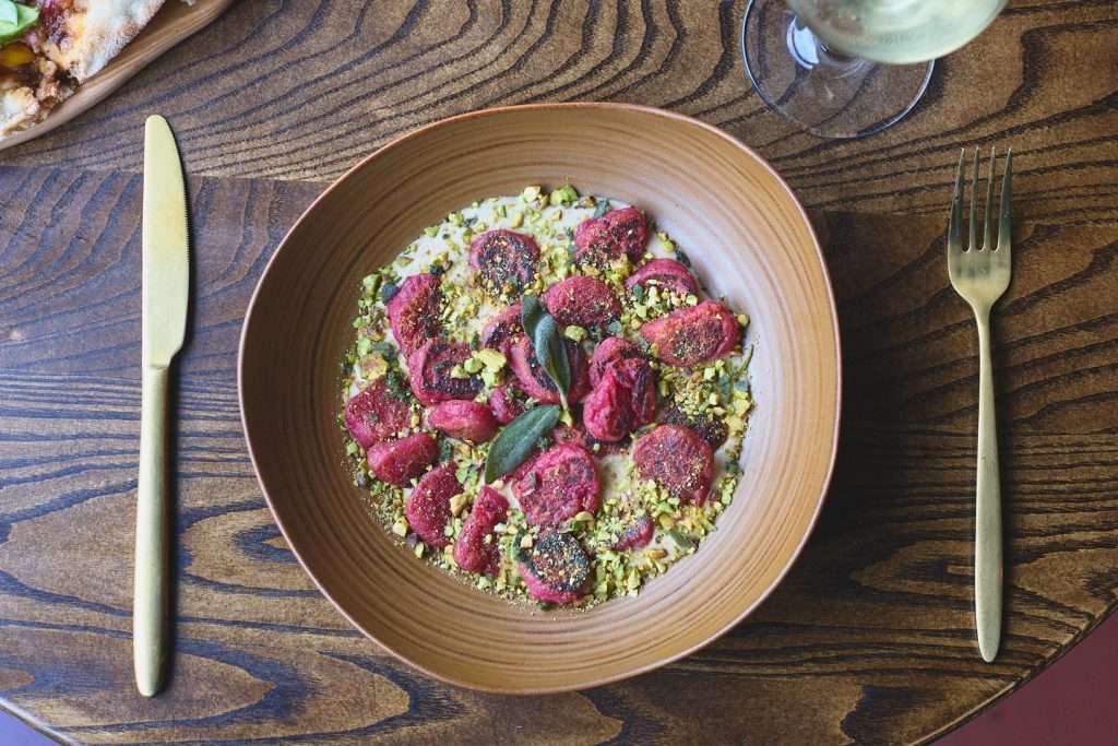 Minneapolis Restaurant Design 8 Colorful dish with garnished pasta, restaurant design by Tiffany Hanken