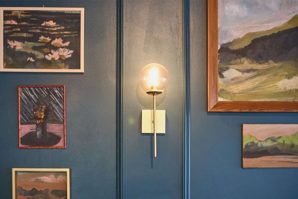 Minneapolis Restaurant Design 6 Artworks on blue wall with lamp in Minneapolis restaurant
