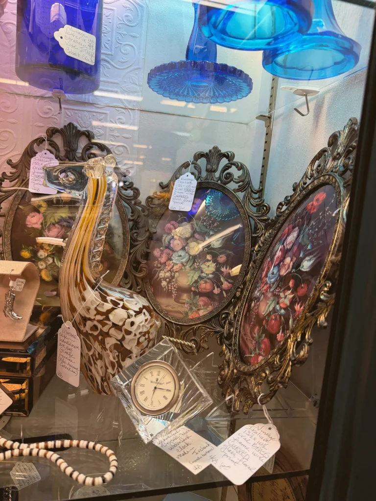 Esther's Table: Bringing a Legendary Minneapolis Hostess Back to the Table 15 Vintage Italian brass frames and hand blown art glass in an antique shop display case
