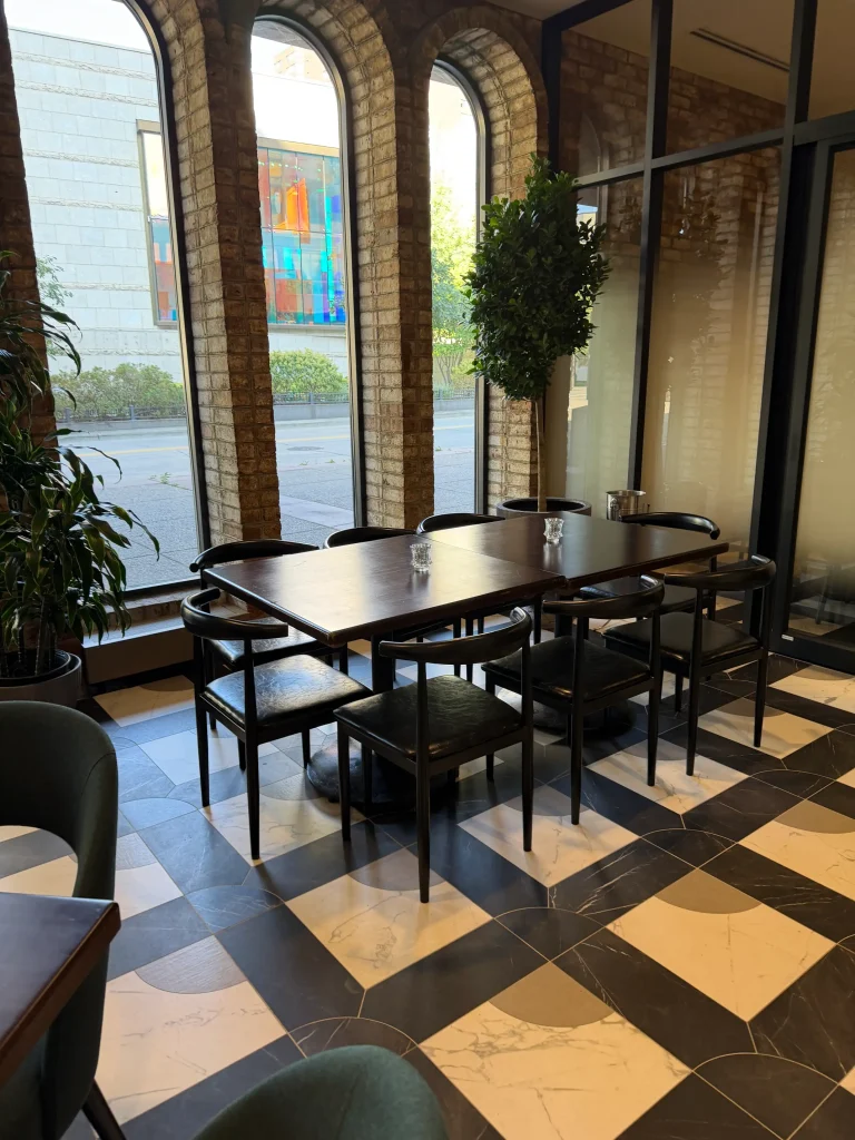 Esther's Table: Restaurant Interior Design, Minneapolis 25 Group dining table beneath original arched brick windows over Nicollet Mall