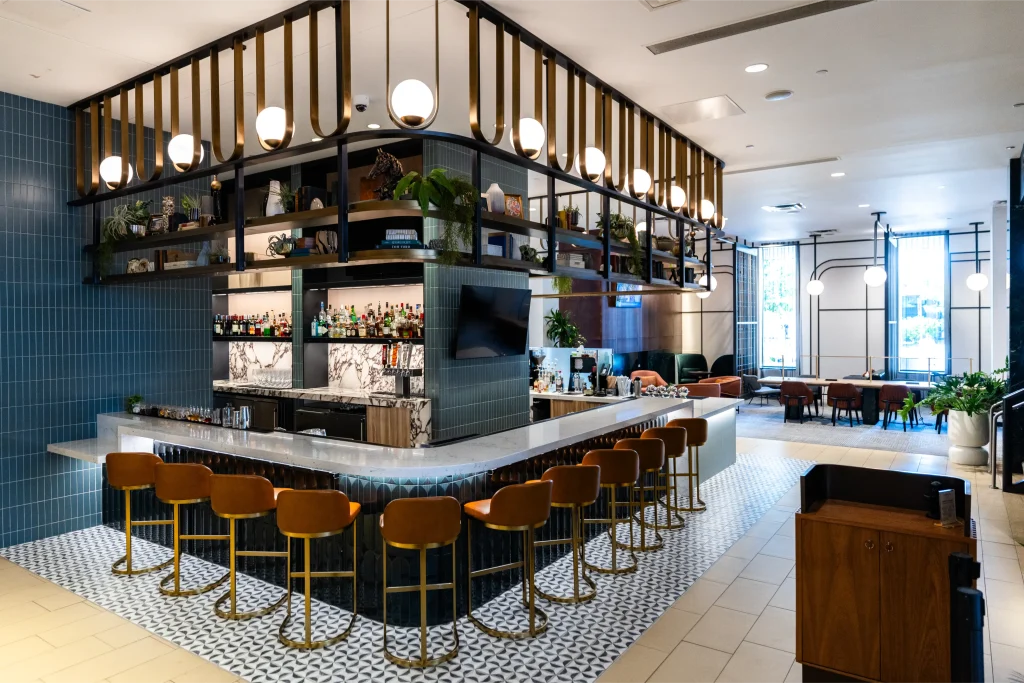 Esther's Table: Restaurant Interior Design, Minneapolis 15 Wide view of the Esther's Table bar with brass globe lights, cognac stools and the adjoining lounge seating