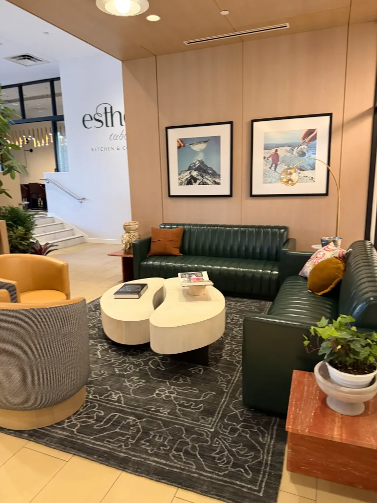 Esther's Table: Restaurant Interior Design, Minneapolis 28 Lounge with green channel-tufted leather sofas, sculptural coffee tables and framed vintage art