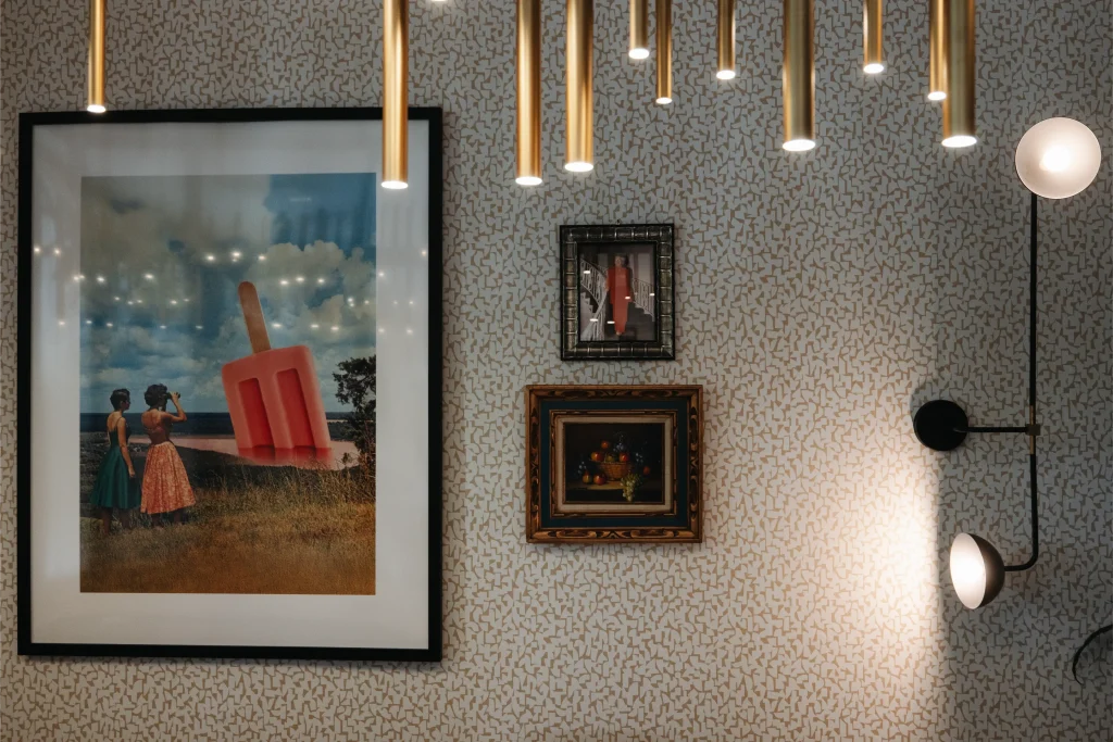 Esther's Table: Restaurant Interior Design, Minneapolis 8 Gallery wall in the private dining room with framed contemporary art, a vintage still life and brass pendant lighting