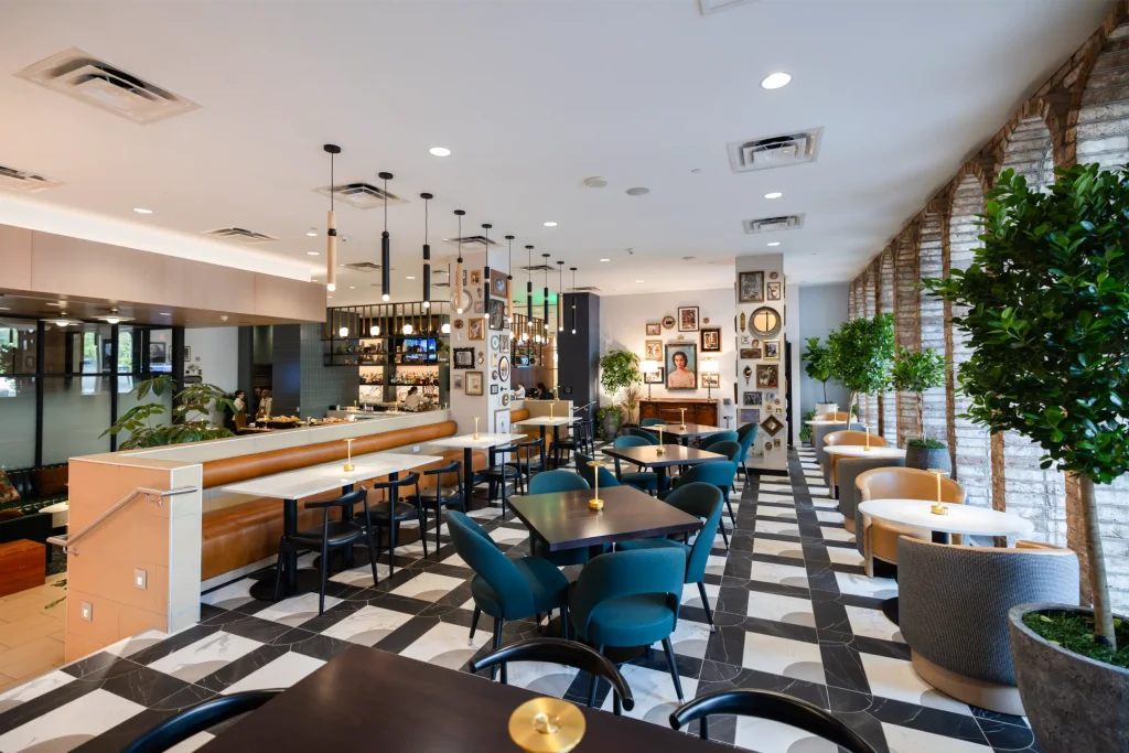 Esther's Table: Restaurant Interior Design, Minneapolis 6 Wide view of the Esther’s Table dining room with checkerboard marble floor, bar, gallery-wall columns and Esther Capp’s portrait